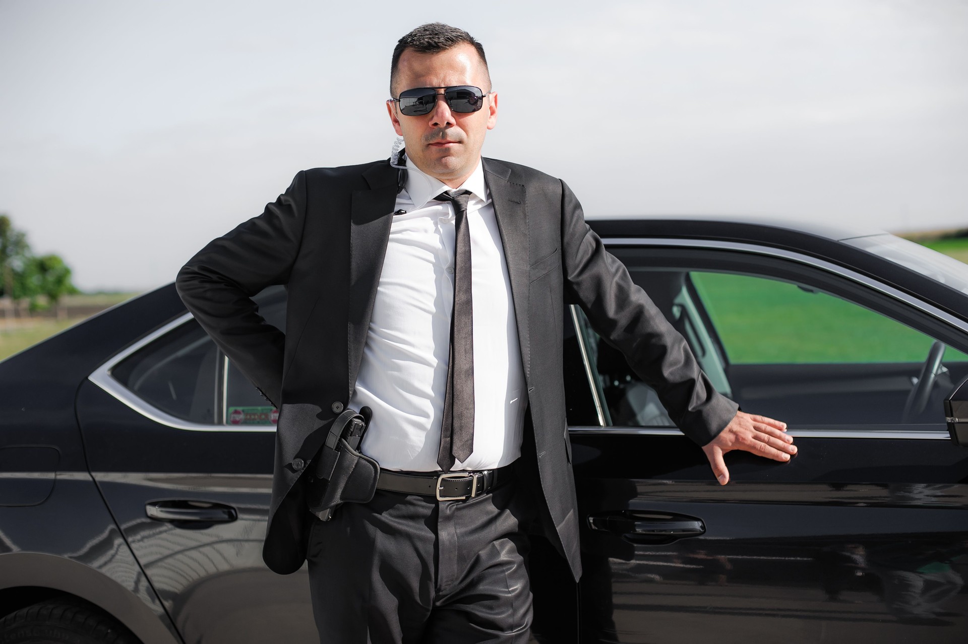 Professional male spy agent bodyguard with gun. Security police protection