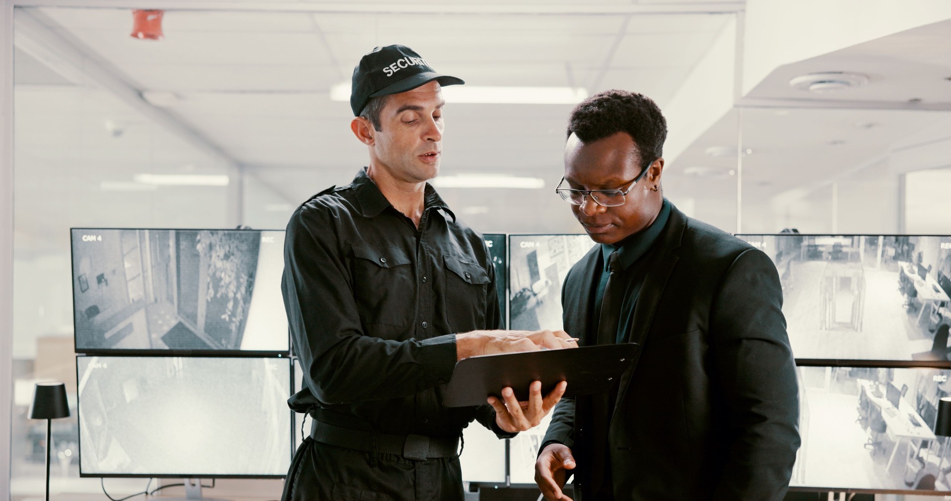 Watching, surveillance and team with tablet, security and review of footage for safety or collaboration. Control room, talking and people with computer for observation, video and protection with tech